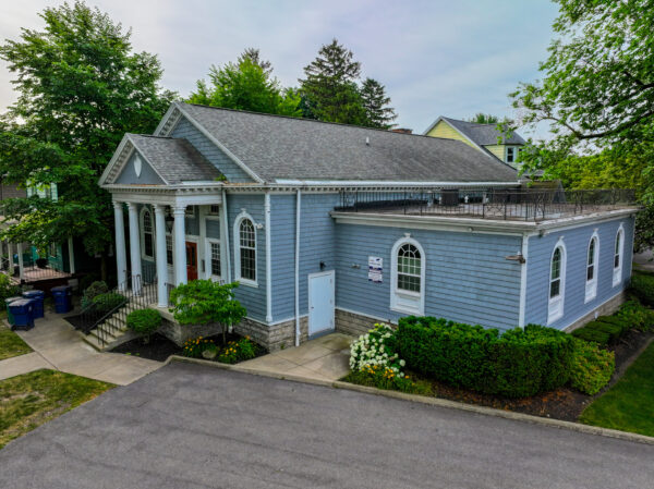 Front of Fairfield Commons. Blue building with several apartments inside.